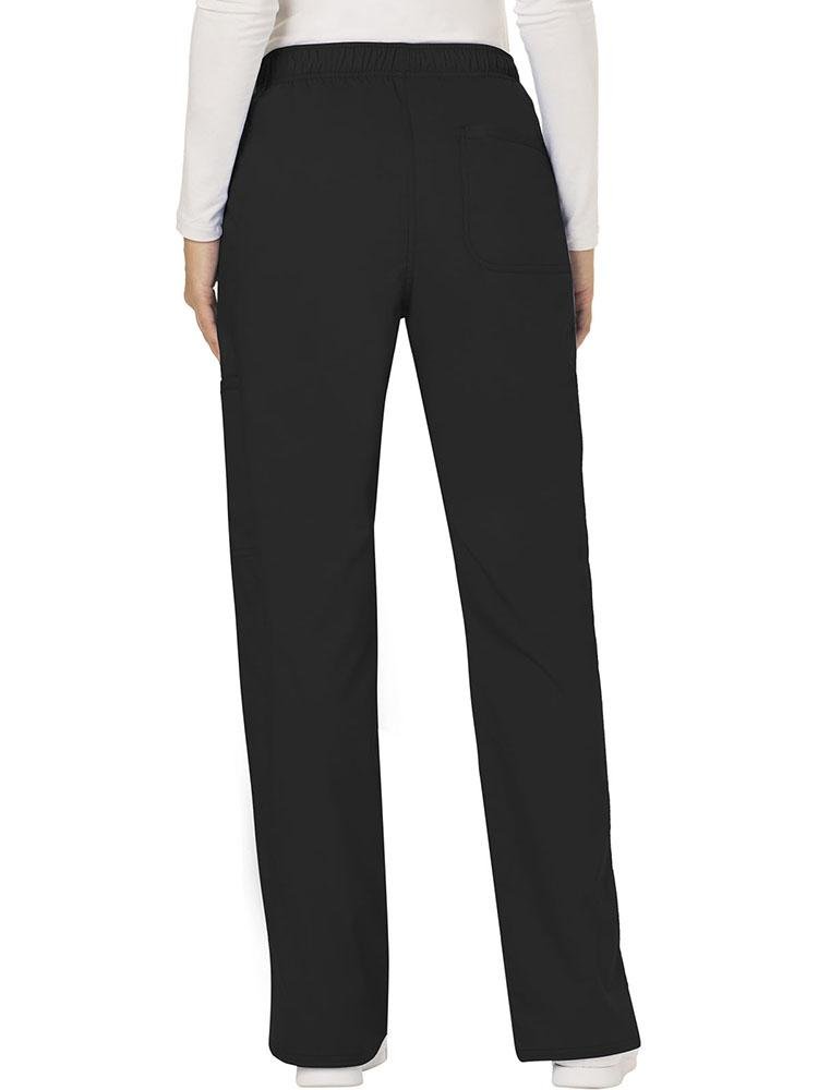A female Diagnostic Medical Sonographer wearing a Cherokee Workwear Revolution Women's Mid Rise Moderate Flare Scrub Pant in Black size Medium Tall featuring a back patch pocket for additional storage space. 