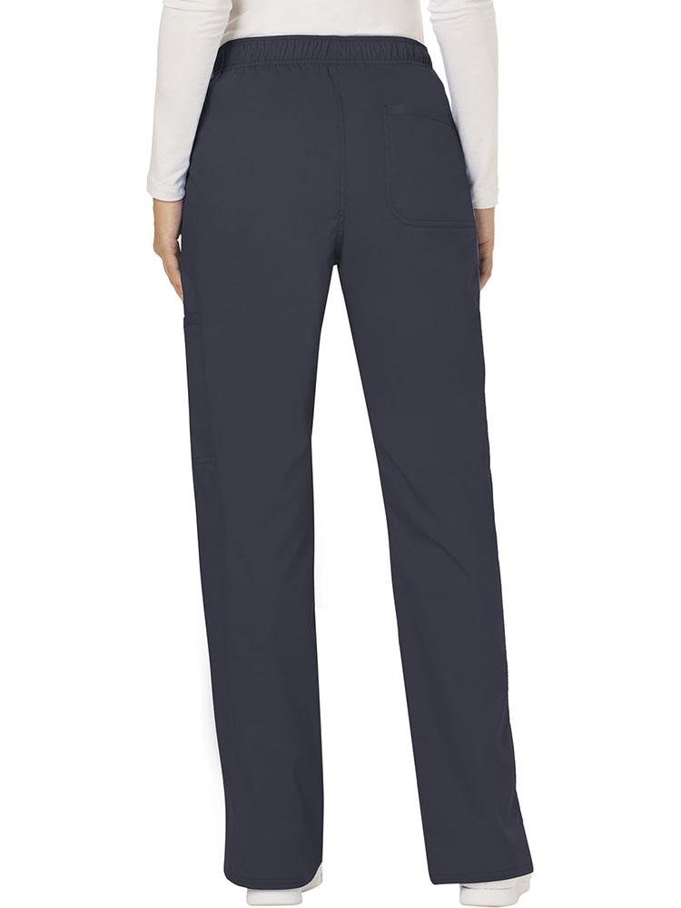 A female Diagnostic Medical Sonographer wearing a Cherokee Workwear Revolution Women's Mid Rise Moderate Flare Scrub Pant in Pewter size Medium Tall featuring a back patch pocket for additional storage space.