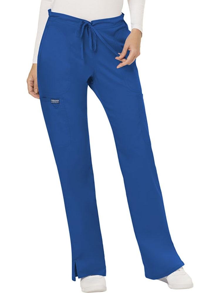 A young female Clinical Laboratory Technician wearing a Cherokee Workwear Revolution Women's Mid Rise Moderate Flare Scrub Pant in Royal Blue size XL Petite featuring a drawstring waist to provide a flattering & comfortable all day fit.