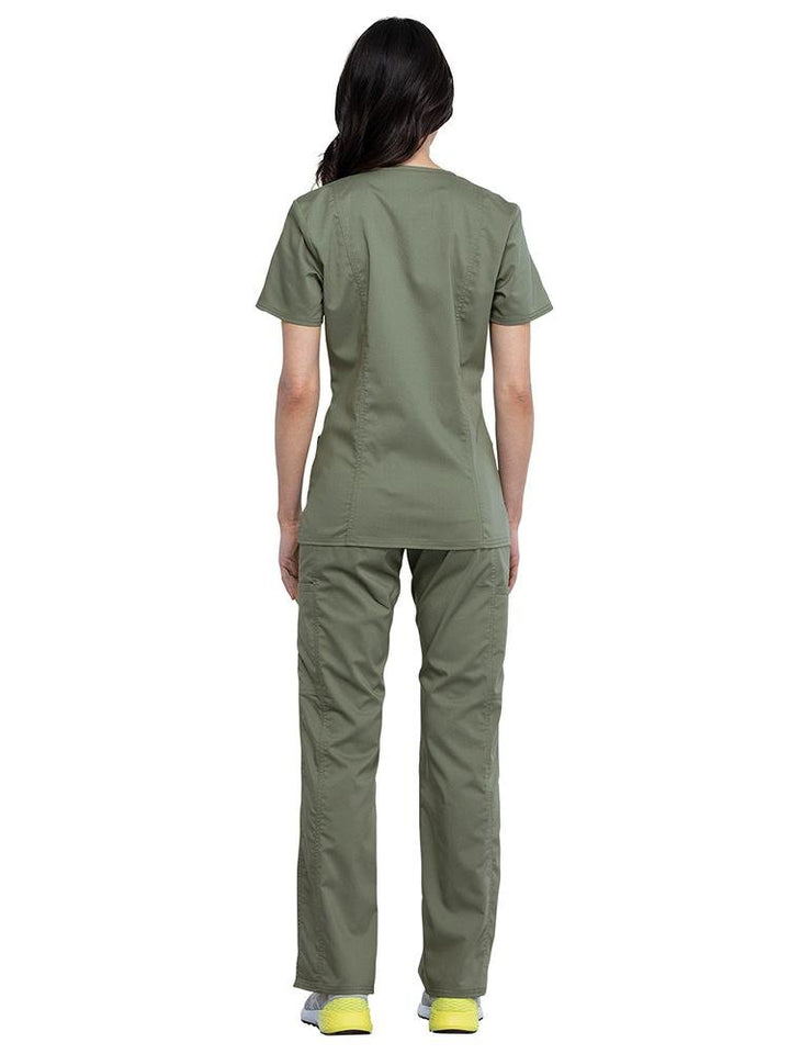 Back view of CNA wearing Cherokee Workwear Revolution women's Mock Wrap Scrub Top & Elastic Waist Scrub Pant in olive size medium