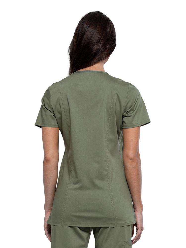 Back view of Occupational Therapist wearing Cherokee Workwear Revolution women's V-Neck Scrub Top in olive size large