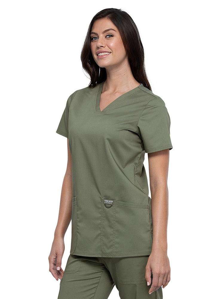Pediatrician wearing Cherokee Workwear Revolution women's V-Neck Scrub Top in olive size extra large