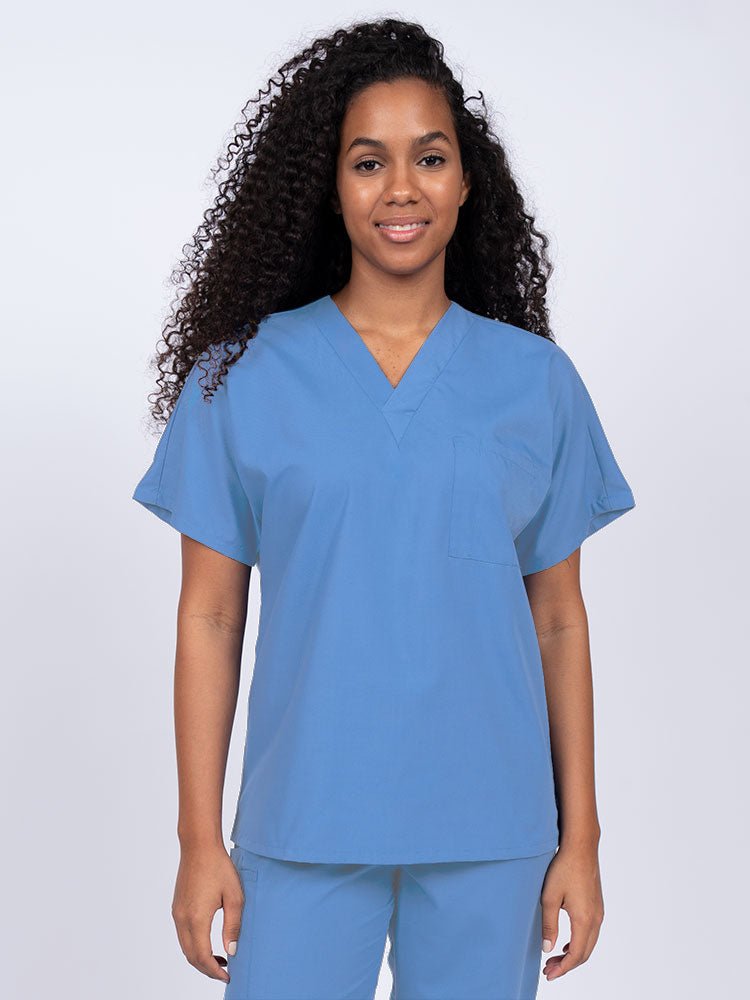 Young woman wearing a Luv Scrubs Unisex Single Pocket Scrub Top in ceil featuring a V-neckline.