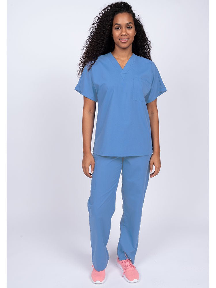 Young woman wearing a Luv Scrubs Unisex Single Pocket Scrub Top in ceil featuring a V-neckline.