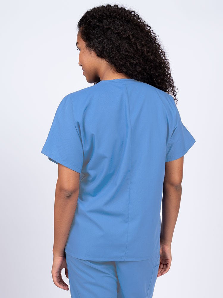 Nurse wearing a Luv Scrubs Unisex Single Pocket V-Neck Scrub Top in ceil with a center back length of 27.5".