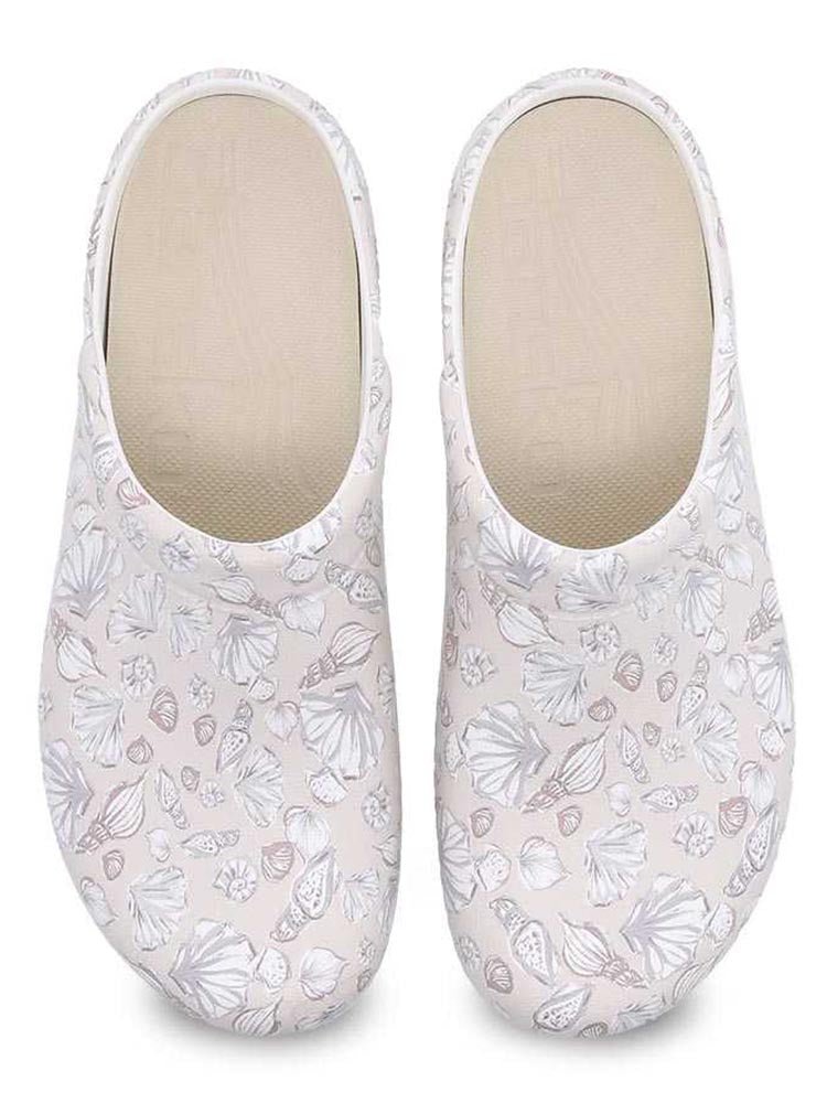 A pair of Dansko Kane Molded Nurse Clogs in Sea Shells with perforated uppers for ventilation.
