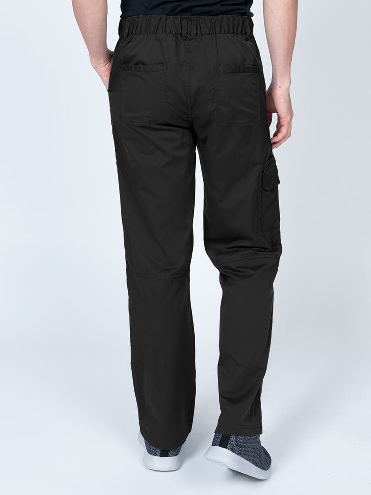 Male nurse wearing an Epic by MedWorks Men's Button Front Scrub Pant in black with 2 back pockets.