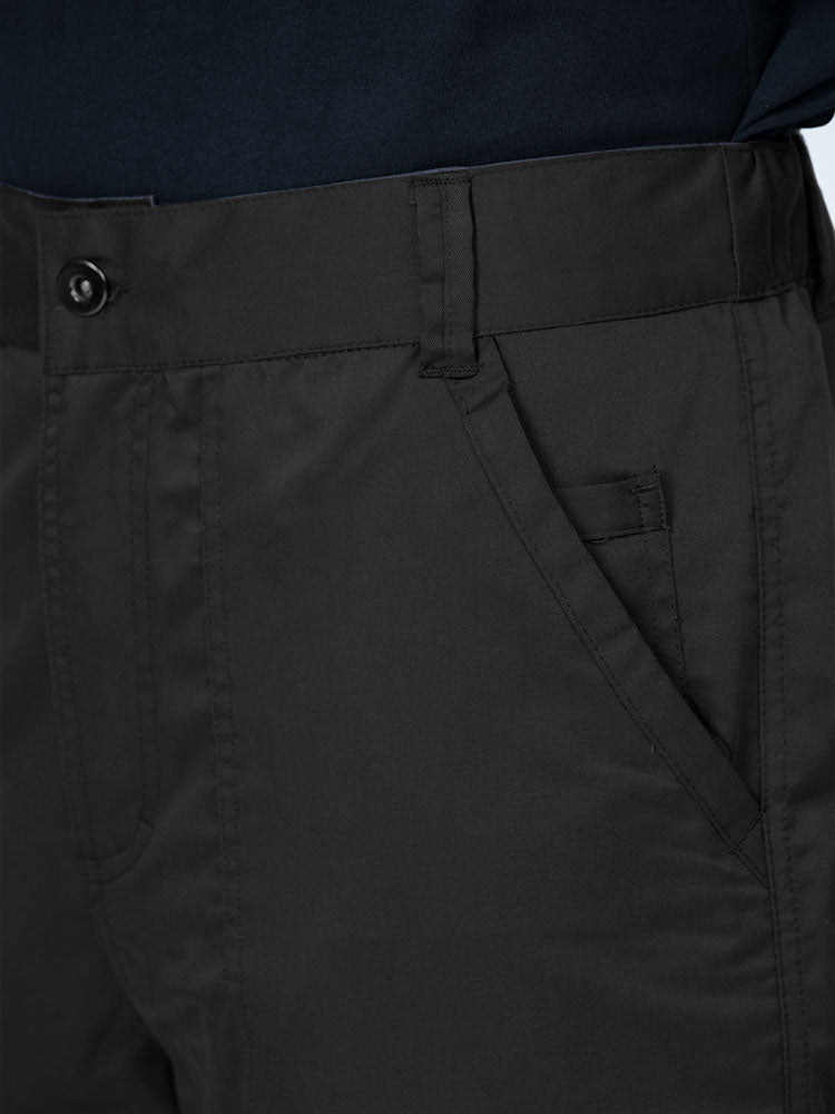 Man wearing an Epic by MedWorks Men's Button Front Scrub Pant in black with a 6 belt loop waistline.