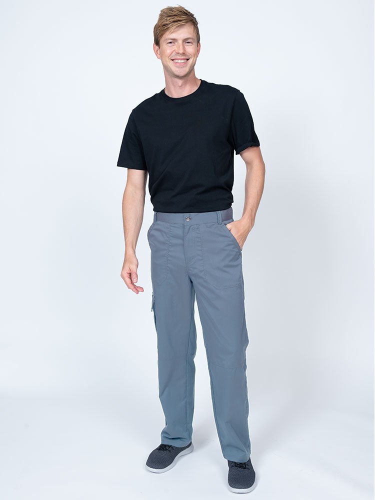 Male nurse practitioner wearing The Men's Button Front Scrub Pant from Epic by MedWorks in blue fog.