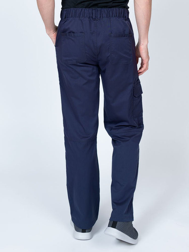 Male nurse wearing an Epic by MedWorks Men's Button Front Scrub Pant in navy with 2 back pockets.