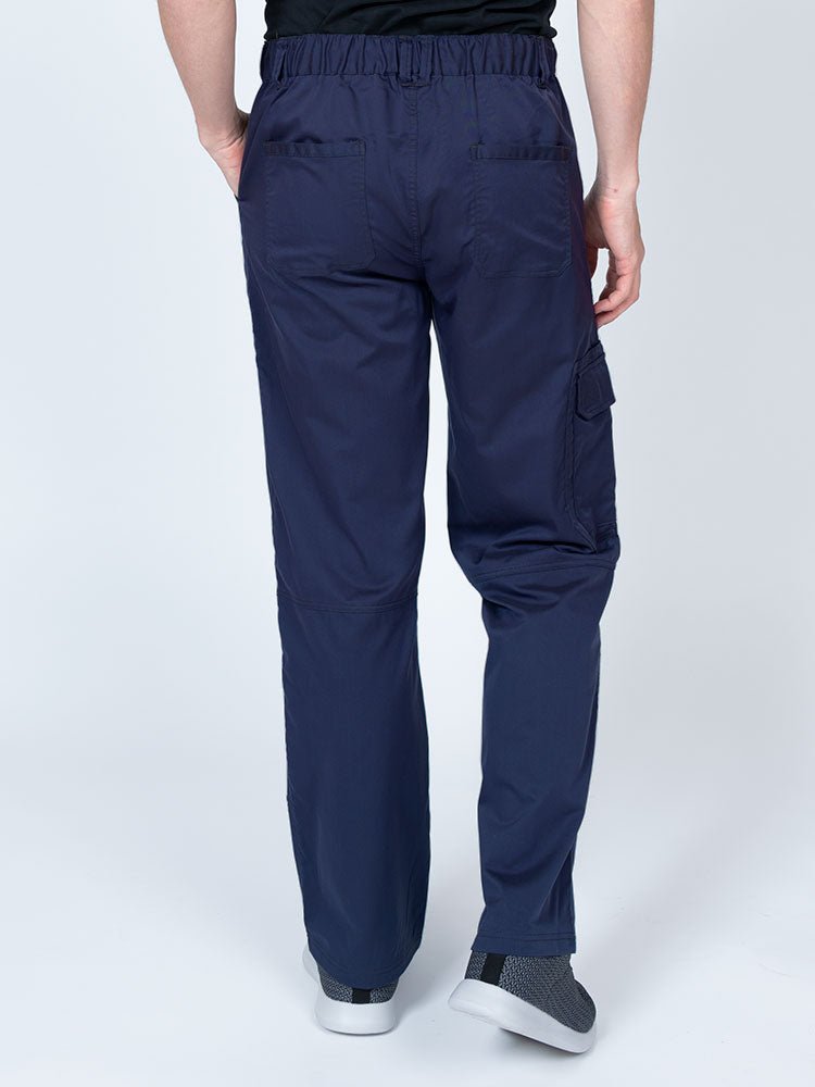 Male nurse wearing an Epic by MedWorks Men's Button Front Scrub Pant in navy with 2 back pockets.