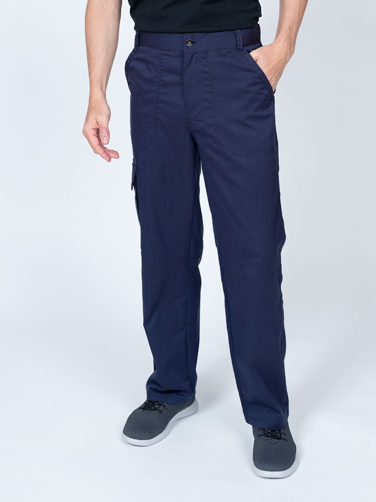 Man wearing an Epic by MedWorks Men's Button Front Scrub Pant in navy with metal button front closure.