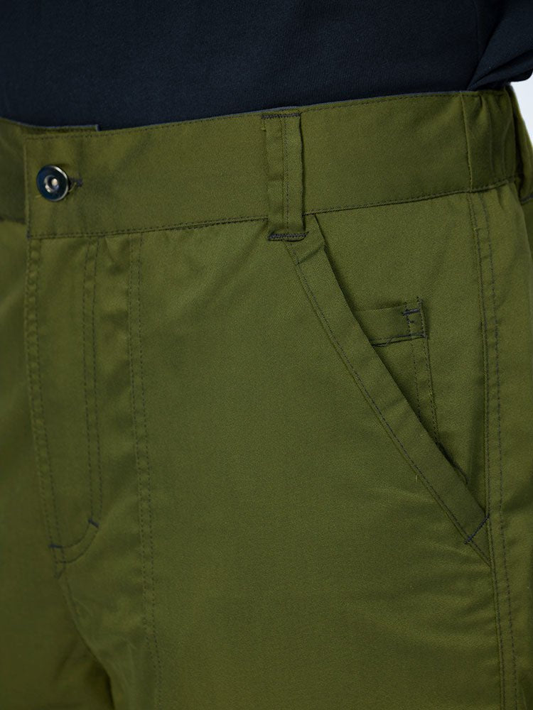 Man wearing an Epic by MedWorks Men's Button Front Scrub Pant in olive with a 6 belt loop waistline.