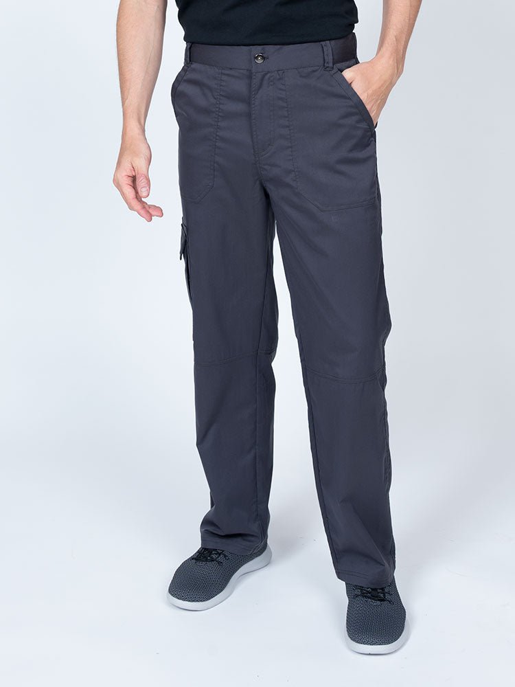 Man wearing an Epic by MedWorks Men's Button Front Scrub Pant in pewter with metal button front closure.