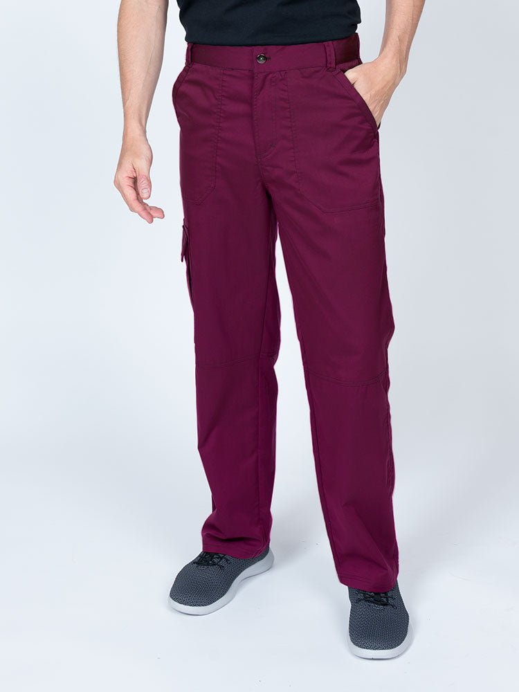 Man wearing an Epic by MedWorks Men's Button Front Scrub Pant in wine with metal button front closure.