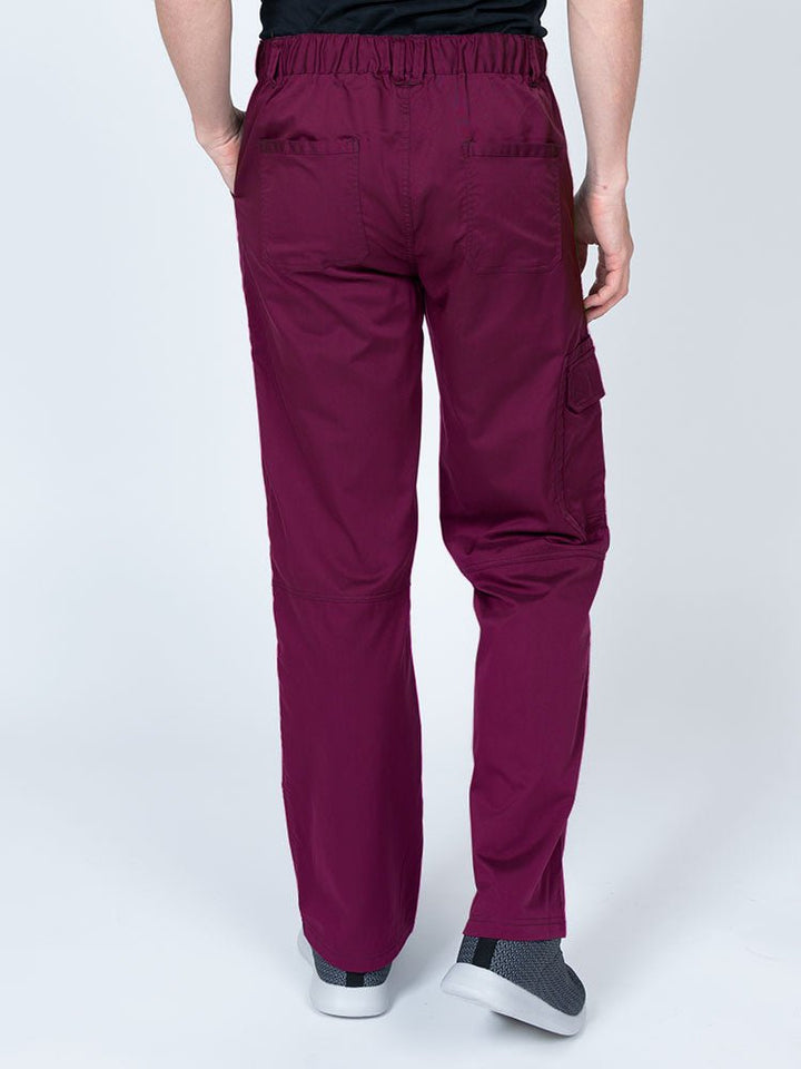 Male nurse wearing an Epic by MedWorks Men's Button Front Scrub Pant in wine with 2 back pockets.