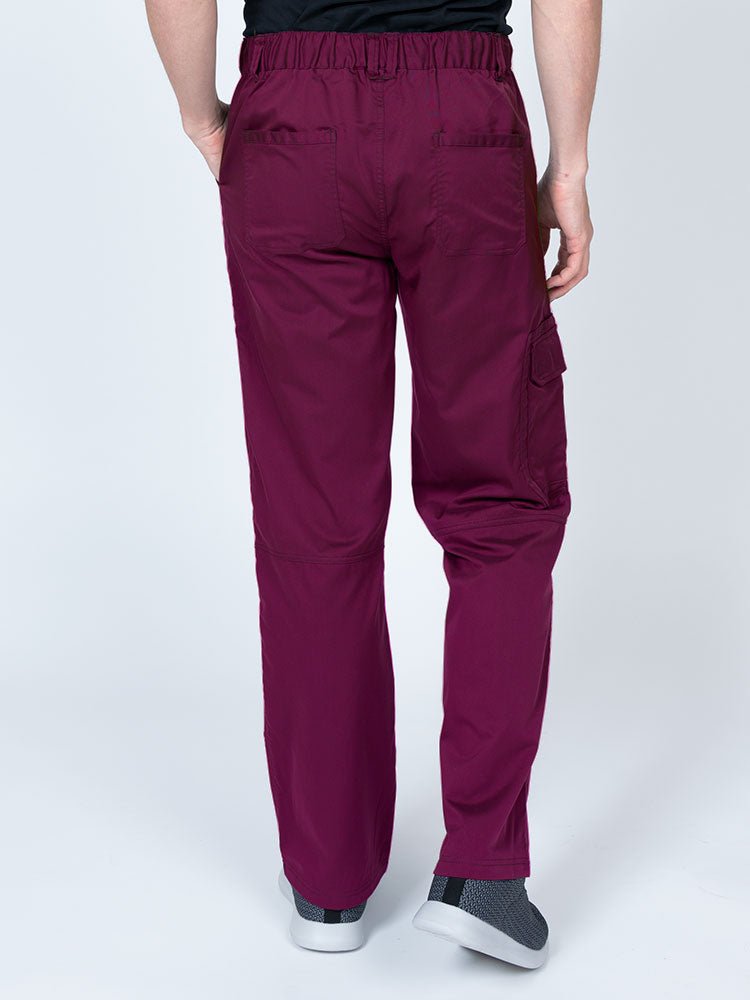 Male nurse wearing an Epic by MedWorks Men's Button Front Scrub Pant in wine with 2 back pockets.