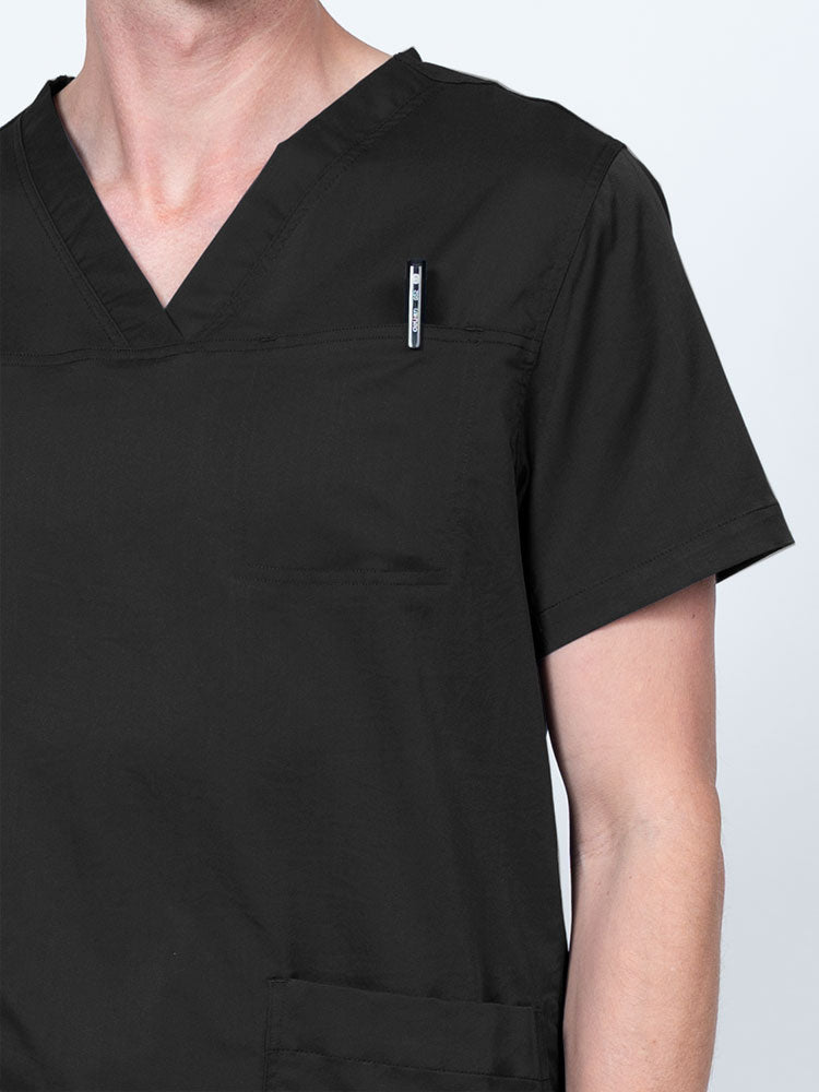 Male nurse wearing an Epic by MedWorks Men's Scrub Top in black with a "hidden" front chest pocket.