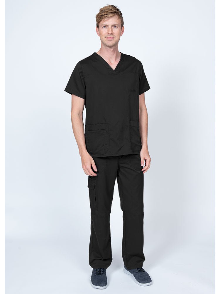 Man wearing an Epic by MedWorks Men's Scrub Top in black with a super soft, 2-way stretch fabric.
