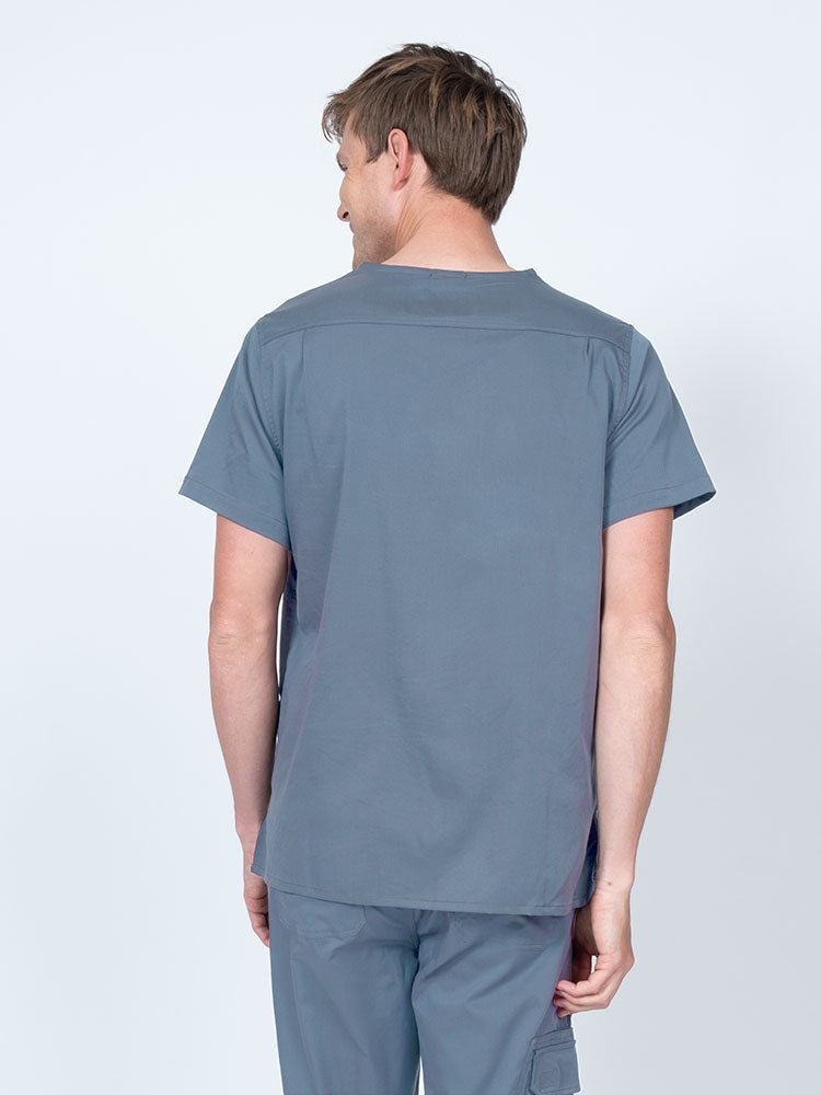 Male nurse wearing an Epic by MedWorks Men's Scrub Top in blue fog with a back yoke to keep a form-fitting look.