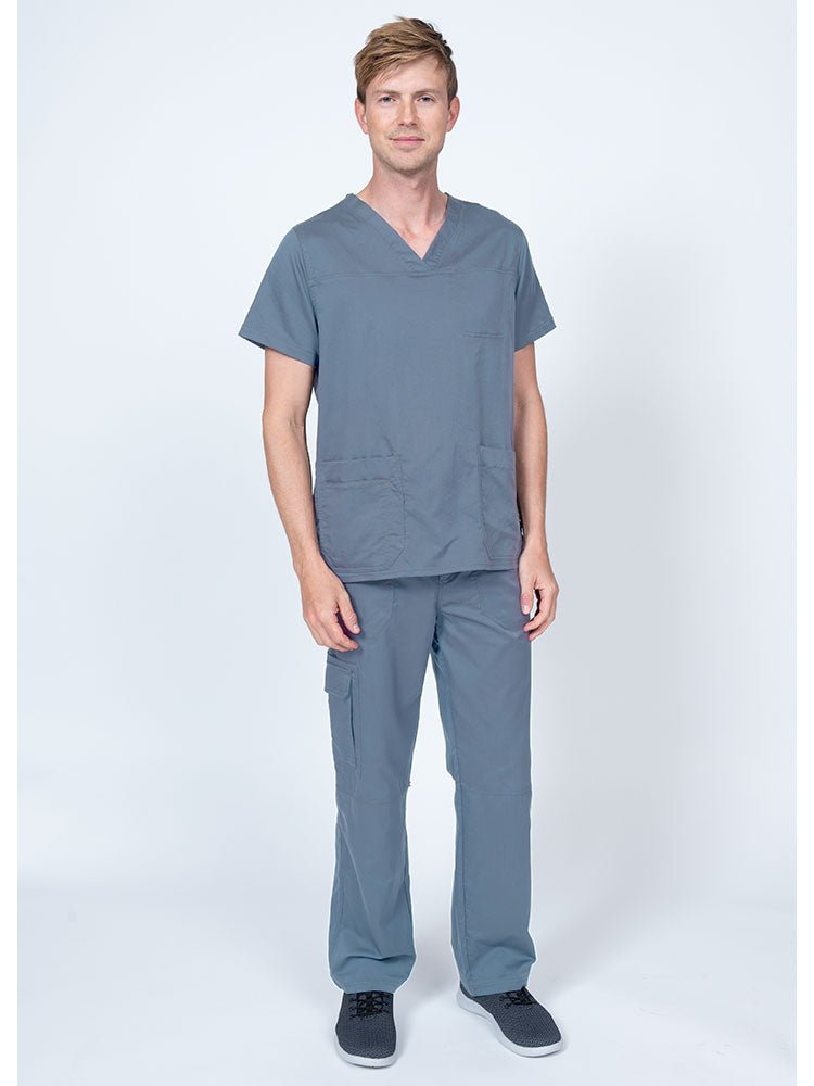 Man wearing an Epic by MedWorks Men's Scrub Top in blue fog with a super soft, 2-way stretch fabric.