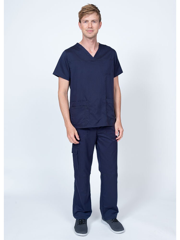 Man wearing an Epic by MedWorks Men's Scrub Top in navy with a super soft, 2-way stretch fabric.