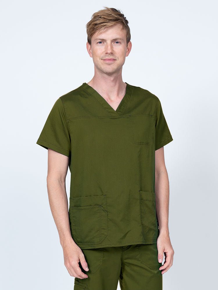 Male healthcare professional wearing an Epic by MedWorks Men's Scrub Top in olive with 2 front patch pockets and 1 exterior cell phone pocket on the wearer's right side.