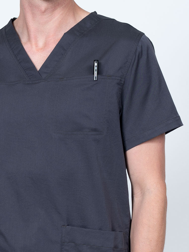 Male nurse wearing an Epic by MedWorks Men's Scrub Top in pewter with a "hidden" front chest pocket.