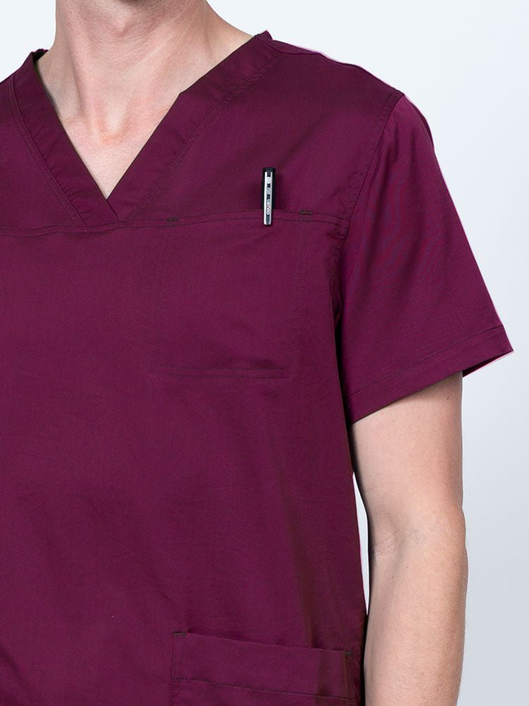Male nurse wearing an Epic by MedWorks Men's Scrub Top in wine with a "hidden" front chest pocket.