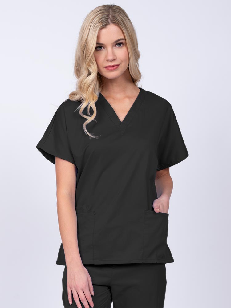 Young nurse wearing an Epic by MedWorks Unisex V-Neck Scrub Top in black with a unique, easy care fabric made of 77% polyester, 21% Viscose and 2% Spandex.