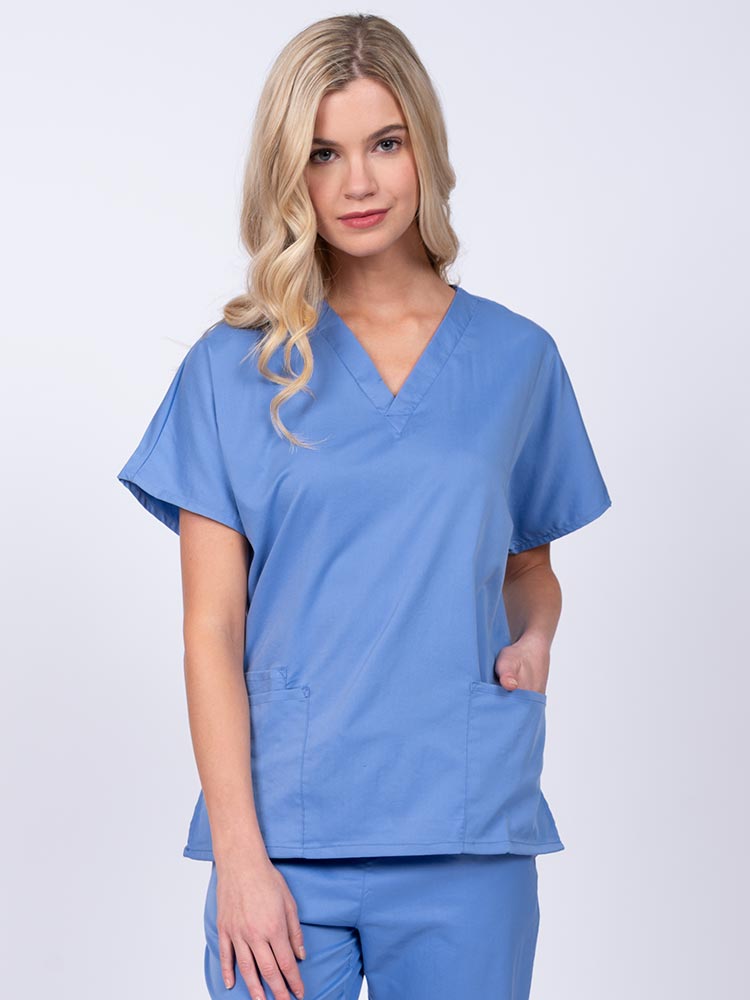 Young nurse wearing an Epic by MedWorks Unisex V-Neck Scrub Top in ceil with a unique, easy care fabric made of 77% polyester, 21% Viscose and 2% Spandex.