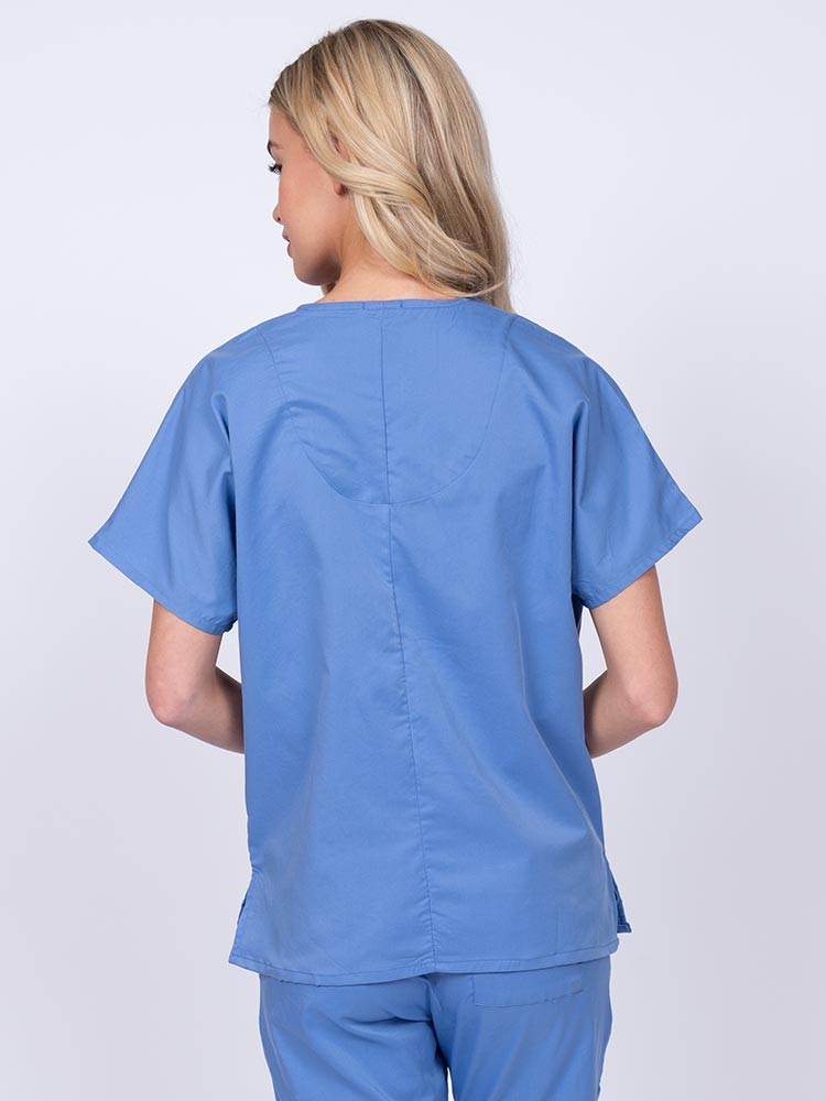 Woman wearing an Epic by MedWorks Unisex V-Neck Scrub Top in ceil with a center back length of 27.5".