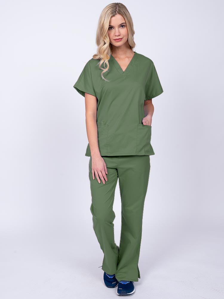 Young woman wearing an Epic by MedWorks Unisex Scrub Top in olive featuring a V-neckline & short sleeves.