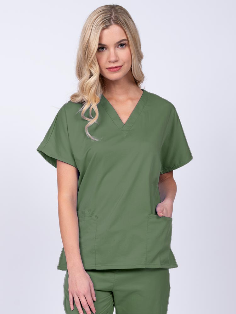 Young nurse wearing an Epic by MedWorks Unisex V-Neck Scrub Top in olive with a unique, easy care fabric made of 77% polyester, 21% Viscose and 2% Spandex.