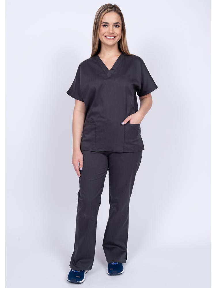 Young woman wearing an Epic by MedWorks Unisex Scrub Top in pewter featuring a V-neckline & short sleeves.