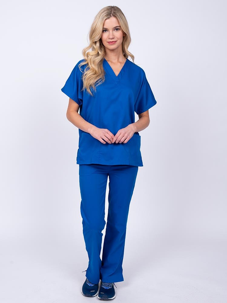 Young woman wearing an Epic by MedWorks Unisex Scrub Top in royal featuring a V-neckline & short sleeves.