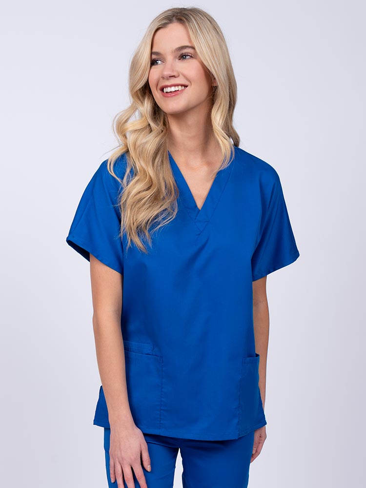 Young nurse wearing an Epic by MedWorks Unisex V-Neck Scrub Top in royal with a unique, easy care fabric made of 77% polyester, 21% Viscose and 2% Spandex.