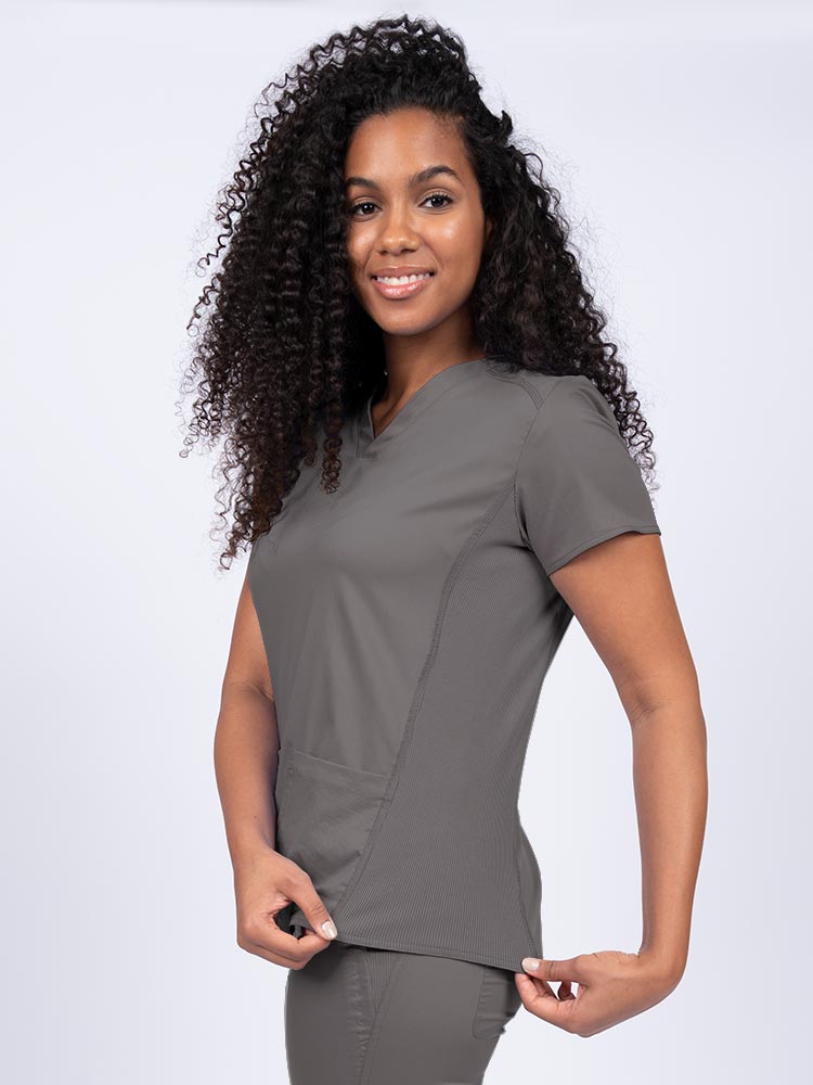 Nurse wearing an Epic by MedWorks Women's Blessed Scrub Top in pewter with stylish seaming throughout.