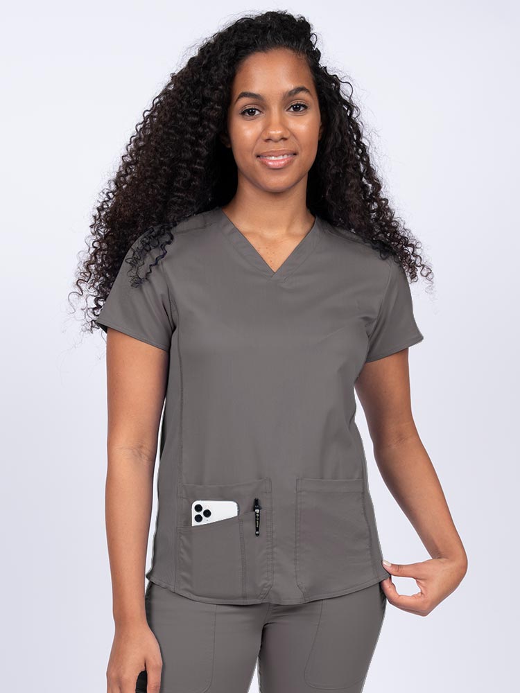 Nurse wearing an Epic by MedWorks Women's Blessed Scrub Top in pewter with a V-neckline & short sleeves.