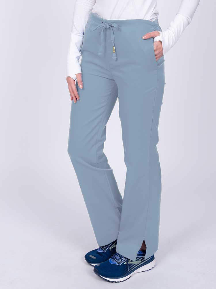 Nurse wearing an Epic by MedWorks Women's Drawstring Flare Leg Scrub Pant in blue fog with side slits for additional mobility.