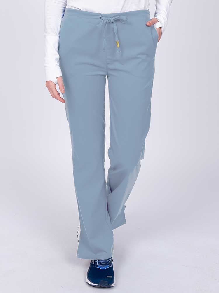 Young nurse wearing an Epic by MedWorks Women's Drawstring Flare Leg Scrub Pant in blue fog with unique stretch fabric made of 77% Polyester, 21% Viscose, 2% Spandex.