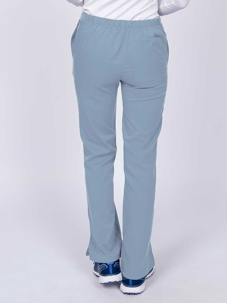 Young healthcare worker wearing an Epic by MedWorks Women's Drawstring Flare Leg Scrub Pant in blue fog featuring a drawstring waist with back elastic.