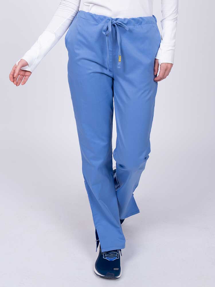 Young nurse wearing an Epic by MedWorks Women's Drawstring Flare Leg Scrub Pant in ceil with unique stretch fabric made of 77% Polyester, 21% Viscose, 2% Spandex.