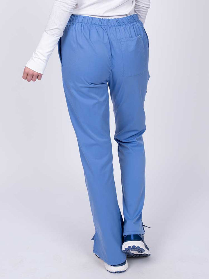 Young healthcare worker wearing an Epic by MedWorks Women's Drawstring Flare Leg Scrub Pant in ceil featuring a drawstring waist with back elastic.