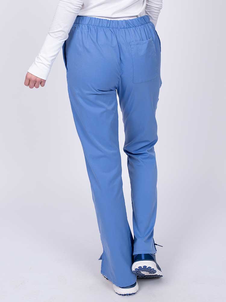 Young healthcare worker wearing an Epic by MedWorks Women's Drawstring Flare Leg Scrub Pant in ceil featuring a drawstring waist with back elastic.