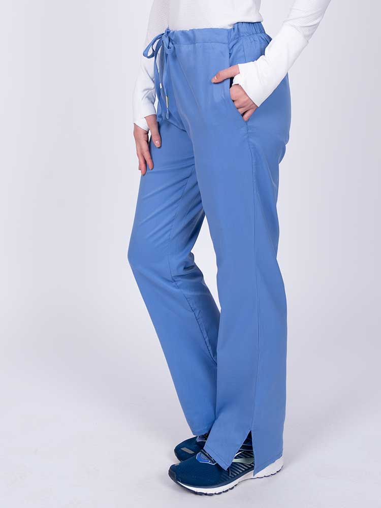 Nurse wearing an Epic by MedWorks Women's Drawstring Flare Leg Scrub Pant in ceil with side slits for additional mobility.