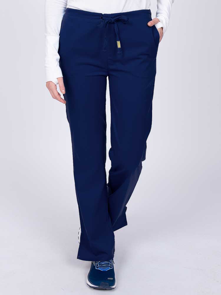 Young nurse wearing an Epic by MedWorks Women's Drawstring Flare Leg Scrub Pant in navy with unique stretch fabric made of 77% Polyester, 21% Viscose, 2% Spandex.
