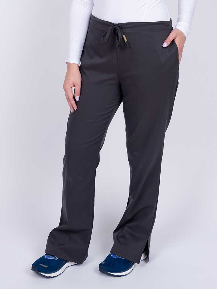 Nurse wearing an Epic by MedWorks Women's Drawstring Flare Leg Scrub Pant in pewter with side slits for additional mobility.