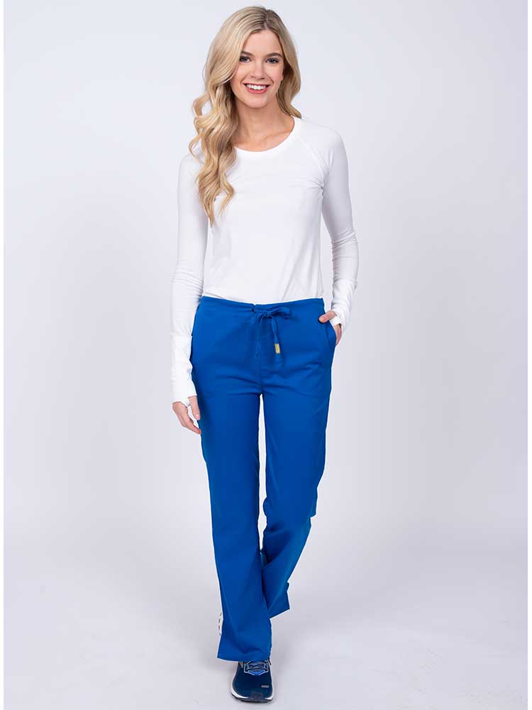 Woman wearing an Epic by MedWorks Women's Drawstring Flare Leg Scrub Pant in royal with 2 front slash pockets & 1 back pocket.