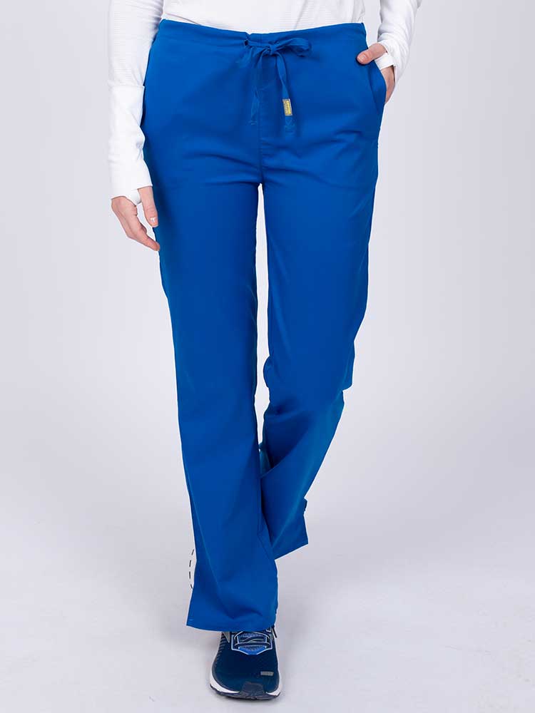 Young nurse wearing an Epic by MedWorks Women's Drawstring Flare Leg Scrub Pant in royal with unique stretch fabric made of 77% Polyester, 21% Viscose, 2% Spandex.